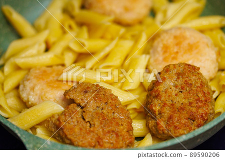 pasta with meatballs in skillet, close-up 89590206