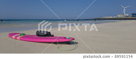 A youthful surfboard ride under the blazing sun 89591154