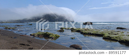 Seongsan Ilchulbong Peak covered with sea fog seen from Gwangchigi Beach after a spring rain Seongsan Ilchulbong Peak covered with sea fog seen from Gwangchigi Beach after a spring rain 89591177