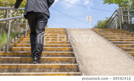 Businessman climbing stairs Businessman climbing stairs 89592418