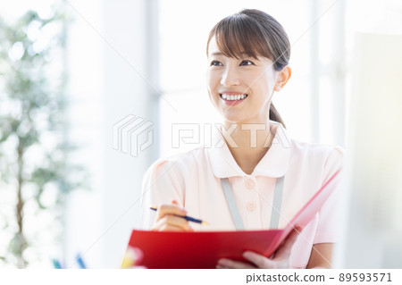 Healthcare worker woman with files and writing utensils in the facility 89593571