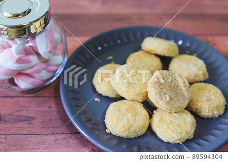 Twisted marshmallows in a vial and porbolone on a plate Twisted marshmallows in a vial and porbolone on a plate 89594304