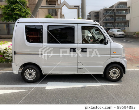 A light van delivering courier services in a residential area A light van delivering courier services in a residential area 89594882