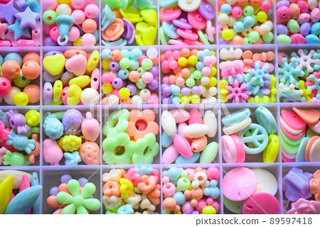 Various Bracelets colorful plastic beads made Cartoon style hand made in box. Variety of shapes and colors to make a bead necklace or a string of beads for women, diy concept Various Bracelets colorful plastic beads made Cartoon style hand made in box. Variety of shapes and colors to make a bead necklace or a string of beads for women, diy concept 89597418