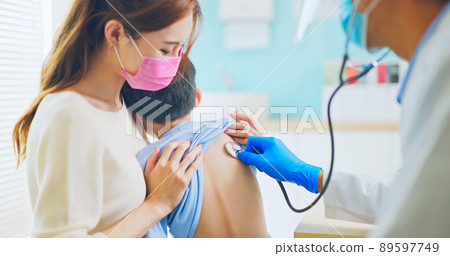 pediatrician examining sick boy 89597749