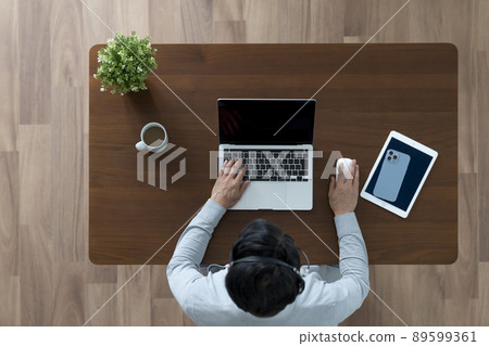 Work at home image Middle-aged man doing desk work Work at home image Middle-aged man doing desk work 89599361