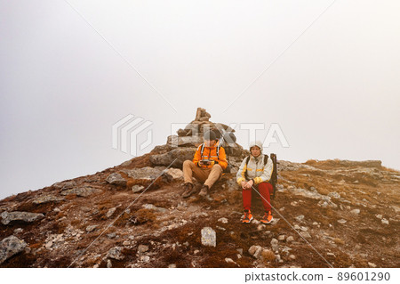 Tourists walk through the Ukrainian Carpathians, tourists carry heavy backpacks on their backs. 89601290