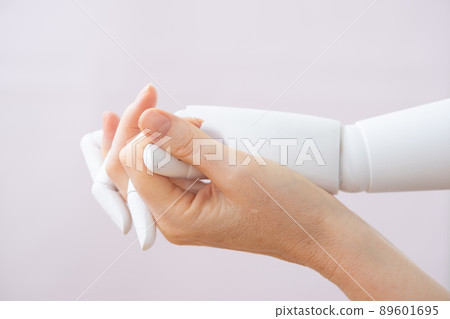 Robot and human fingers are intertwined. Love and passion between machine and man. Or a relationship with a disabled person who lost his arm. Prosthetic arm 89601695
