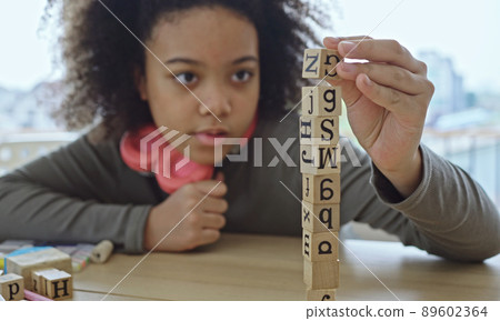 African American student doing activity playing block wooden for development together with enjoy and fun in the classroom. 89602364
