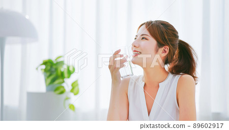 woman takes vitamin or medicine 89602917