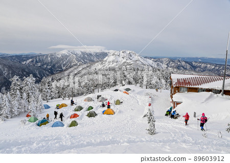 Mountains of the Northern Alps at sunrise seen from the tent field during the snowy season in spring 89603912