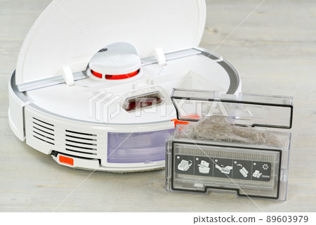 robot vacuum cleaner water tank removed and the filter lid is opened to clean. Smart cleaning and washing technology. advanced robot. robot vacuum cleaner water tank removed and the filter lid is opened to clean. Smart cleaning and washing technology. advanced robot. 89603979
