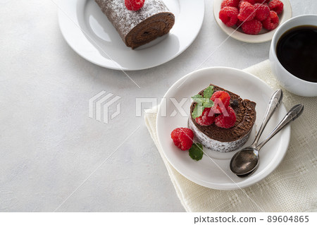 Chocolate roll cake or swiss dessert with raspberries. Copy space. Chocolate roll cake or swiss dessert with raspberries. Copy space. 89604865