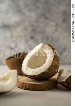 Coconut fresh nut fruit pieces on bright background Coconut fresh nut fruit pieces on bright background 89605394