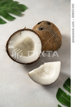 Coconut fresh nut fruit pieces on bright background 89605395