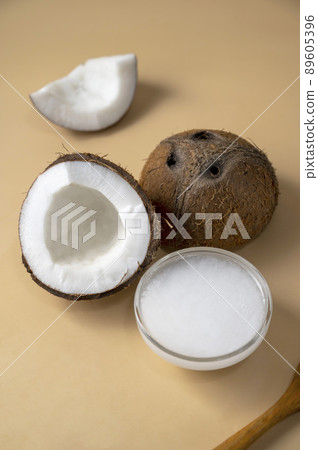 Coconut oil with fresh nut. Healthy alternative oil for cooking and skin care. 89605396
