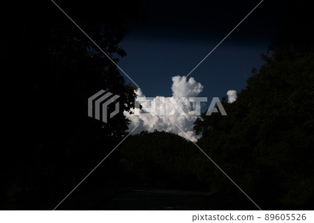 A magnificent cumulonimbus cloud that springs up over a mountain road A magnificent cumulonimbus cloud that springs up over a mountain road 89605526