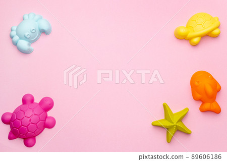 Plastic beach toy pastel color on pink background. The development of fine motor concept. Creativity Game and summer concept. Plastic beach toy pastel color on pink background. The development of fine motor concept. Creativity Game and summer concept. 89606186