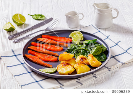 salmon slices with spinach leaves, roast potatoes salmon slices with spinach leaves, roast potatoes 89606289