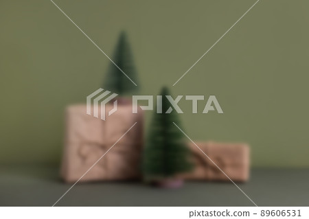 Celebratory Christmas and New Year's holidays background. Gift boxes wrapped craft paper with twine , recycling present on green background Celebratory Christmas and New Year's holidays background. Gift boxes wrapped craft paper with twine , recycling present on green background 89606531