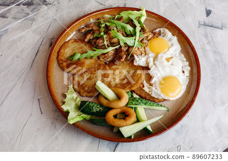 Delicious potato puncakes served with fried eggs. 89607233