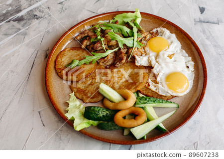 Delicious potato puncakes served with fried eggs. Delicious potato puncakes served with fried eggs. 89607238