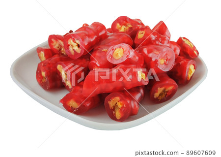 Fresh Churchkhela with walnuts in a plate isolated on white background. Georgian homemade sweet dessert.  89607609