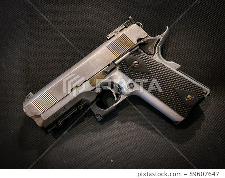 Old and dirty pistol gun on the fabric background Old and dirty pistol gun on the fabric background 89607647