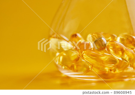 Omega-3 fatty acid capsules on a blue background in a flask. The concept of medicine and healthy living. Front view. 89608945