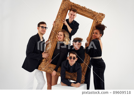 studio portrait of Beautiful young diverse group of friends isolated on white background in the frame for a picture, goofy face, good mood studio portrait of Beautiful young diverse group of friends isolated on white background in the frame for a picture, goofy face, good mood 89609518