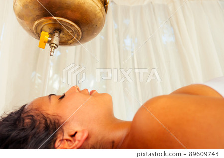 young woman doing healthcare indian traditional treatment in Ayurveda body constitution centre 89609743