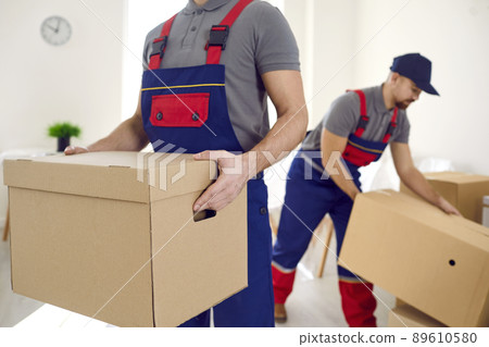 Male movers with boxes unload client belongings Male movers with boxes unload client belongings 89610580