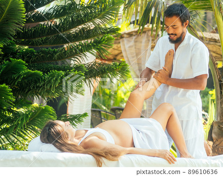 happy pregnancy wife and asian husband doing couple meditation in green park by sea beach happy pregnancy wife and asian husband doing couple meditation in green park by sea beach 89610636