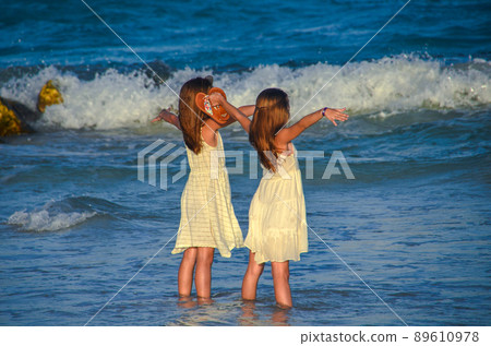 Two girls at the sea. Two girls at the sea. 89610978