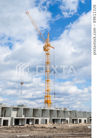 Tall cranes and building of houses Tall cranes and building of houses 89611326