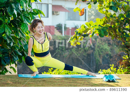 happy asian armless woman warming up before swimming at the tropical beach happy asian armless woman warming up before swimming at the tropical beach 89611390