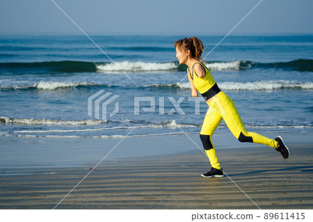 happy asian armless woman warming up before swimming at the tropical beach happy asian armless woman warming up before swimming at the tropical beach 89611415