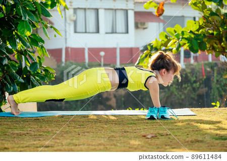 happy asian armless woman warming up before swimming at the tropical beach happy asian armless woman warming up before swimming at the tropical beach 89611484