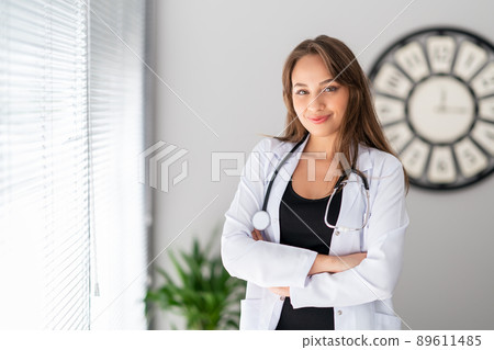 A attractive female doctor is looking with, confidence and pretty smile . A attractive female doctor is looking with, confidence and pretty smile . 89611485