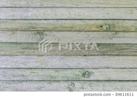 Old wooden worn fence boards weathered texture in peeling green paint dirty obsolete background Old wooden worn fence boards weathered texture in peeling green paint dirty obsolete background 89611611