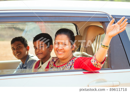 indian family driving boys to school In front of house gates indian family driving boys to school In front of house gates 89611718