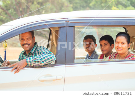 indian family buying a new car and ready to go on beach vacation indian family buying a new car and ready to go on beach vacation 89611721