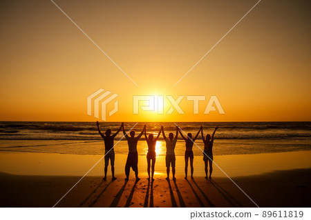six health people in stand hatha position with hand up raced and breath full chest in Goa India beach at sunset six health people in stand hatha position with hand up raced and breath full chest in Goa India beach at sunset 89611819