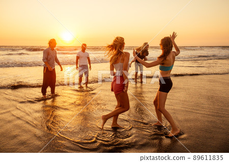 multicultural multinational happy people running into the sun carefree and happiness, vacation on sea multicultural multinational happy people running into the sun carefree and happiness, vacation on sea 89611835