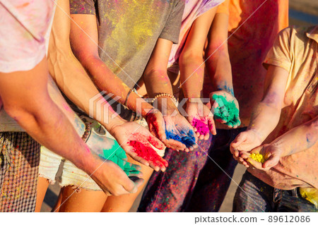 multinational multicultural mixed race friends in holi dust on beach in Goa 89612086
