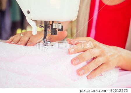 good looking blonde woman with short hair sew underwear in tropics showroom in Bali good looking blonde woman with short hair sew underwear in tropics showroom in Bali 89612275