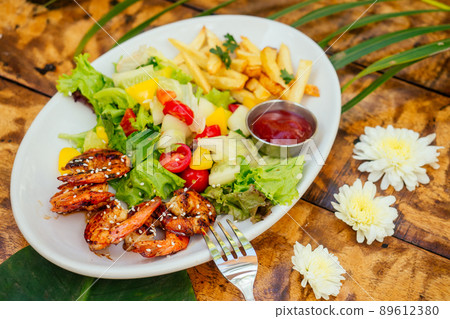 grilled prawns and fryed potato on plate top above view grilled prawns and fryed potato on plate top above view 89612380