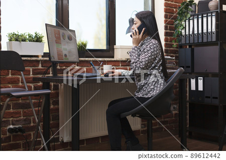 Business research company accountant talking on phone with project manager about marketing strategy. Office assistant informing management board about agency financial issue. Business research company accountant talking on phone with project manager about marketing strategy. Office assistant informing management board about agency financial issue. 89612442