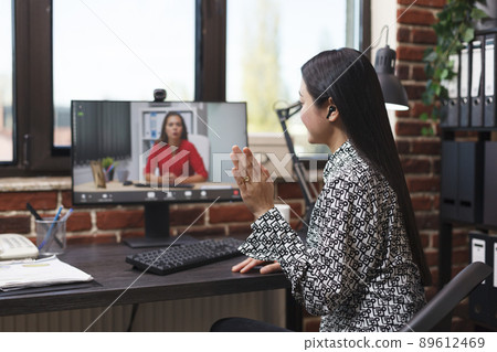 Asian businesswoman waving at webcam videocall digital conference with general manager talking about business financial issue. Asian accountant informing superior about failed startup. 89612469