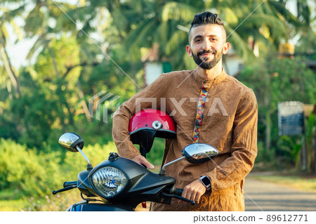 indian man wear helmet and ready to driving explore india attractions of Goa 89612771